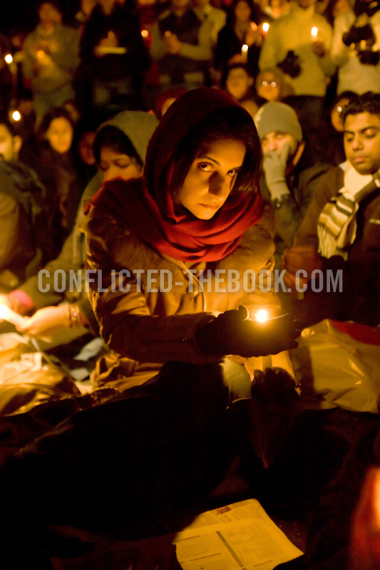 Photograph of a mourner lifting her gaze at a candlelight vigil for victims of Mumbai, Aldwych, 2009