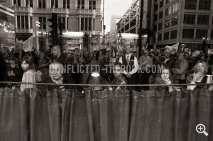 Photograph of Frightened restaurant-goers look out as the crowds running outside, Piccadily, 2009