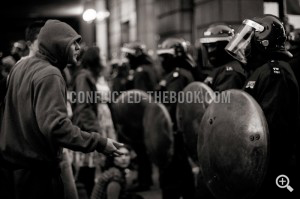 A protester tries to talk to the riot police kettling the climate camp's occupants, Bishopsgate, 2009.