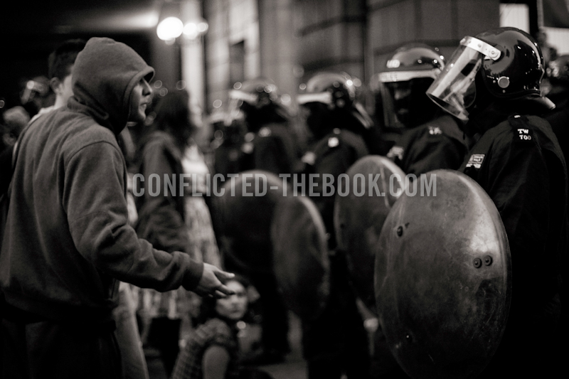 A protester tries to talk to the riot police kettling the climate camp's occupants, Bishopsgate, 2009.